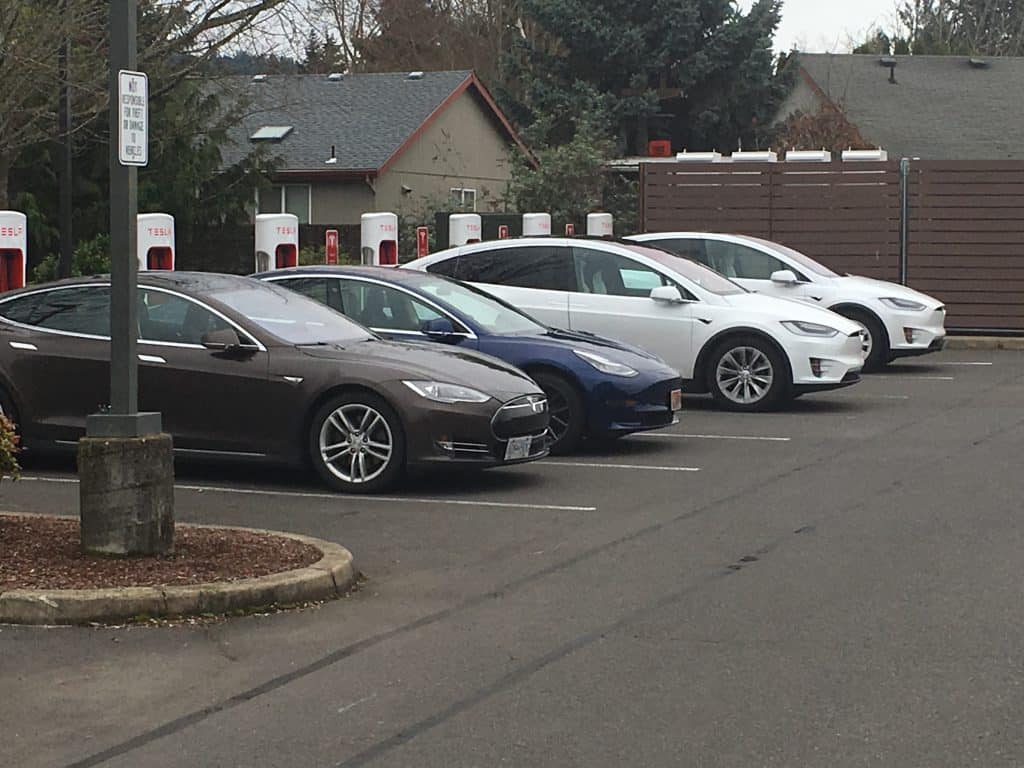 tesla charging at a supercharger station